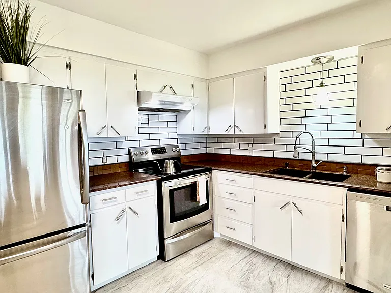 kitchen: stainless steel appliances and ceramic tile backsplashes and flooring with granite countertops