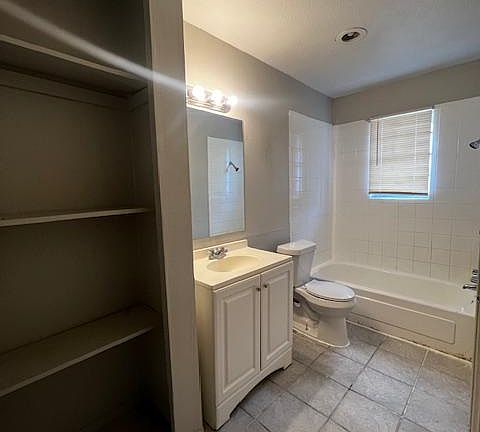 Full bathroom with bathtub and shelves