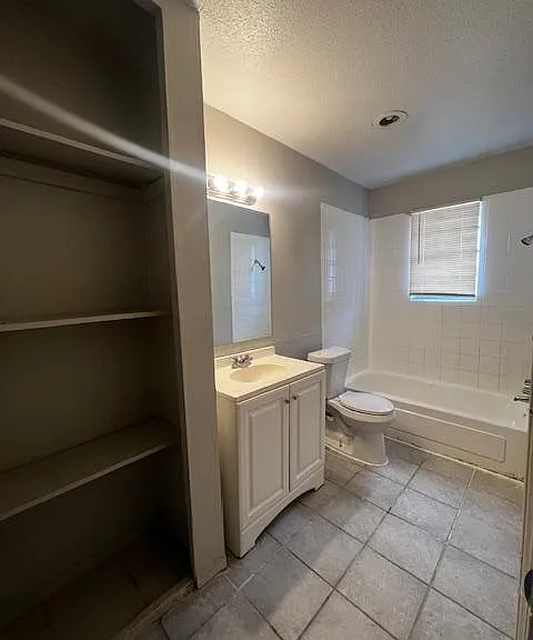 Full bathroom with bathtub and shelves