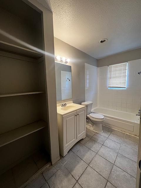 Full bathroom with bathtub and shelves