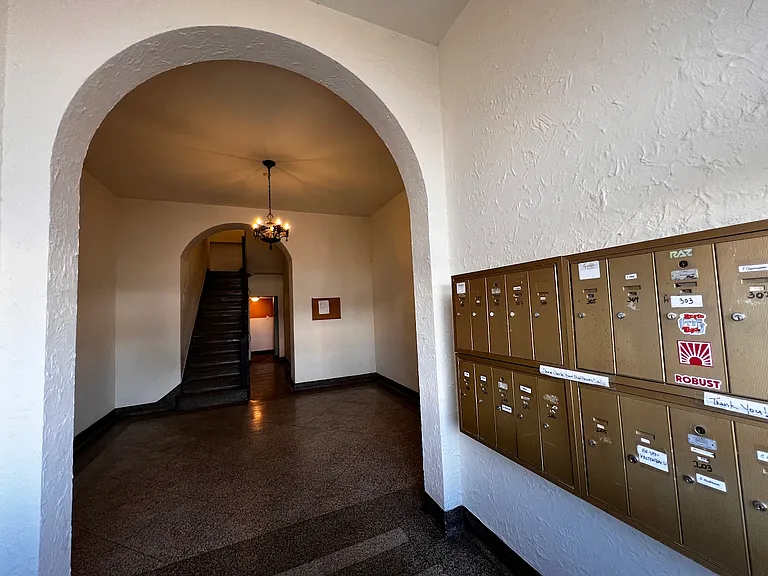 Mail boxes are located next to entrance on Grand.
