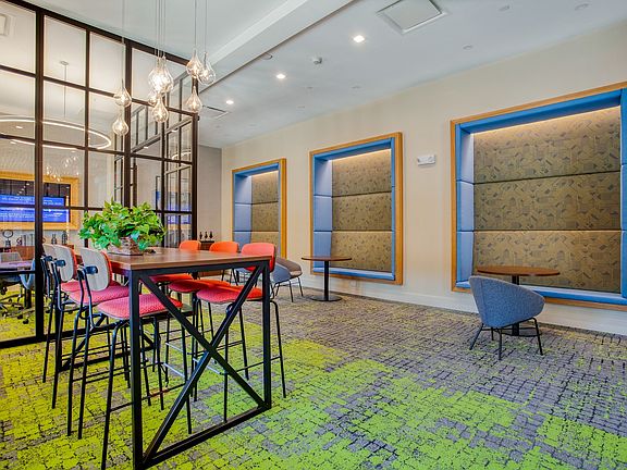 The coworking space features numerous seating areas with outlets built into the chairs and the floor for your convenience