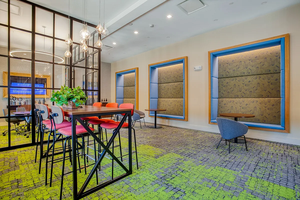 The coworking space features numerous seating areas with outlets built into the chairs and the floor for your convenience - Windsor at Oak Grove