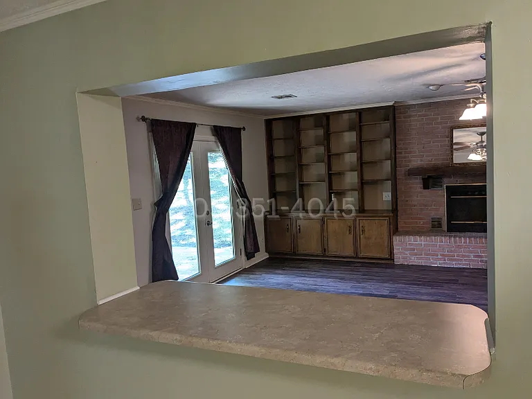 Eat-in kitchen has a pass through window/serving area to a large family room