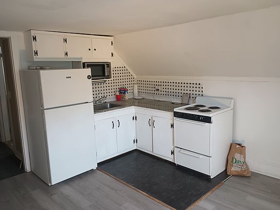 Kitchen with granite countertops
Tile back splash
Full size refrigerator built in micro wave