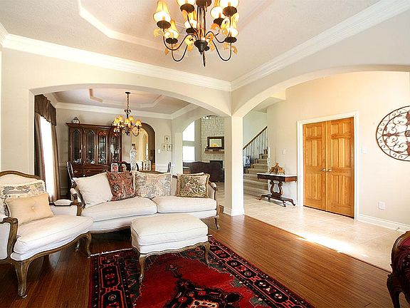 Formal sitting area features bamboo floors, crown molding and a coffered ceiling. And the double doo