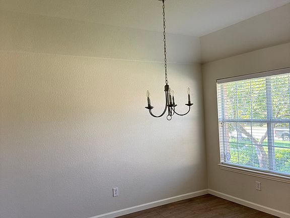 Formal dining room, with new LVP flooring, new baseboards and freshly painted