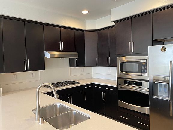Kitchen featuring upgraded GE stainless steel appliances, countertops, and cabinets.