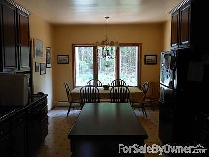 Kitchen and informal dining area
						:
						Large kitchen with work island and tall cherry finish cabinets, all appliances