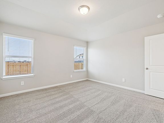Retreat to the primary bedroom after a long day.