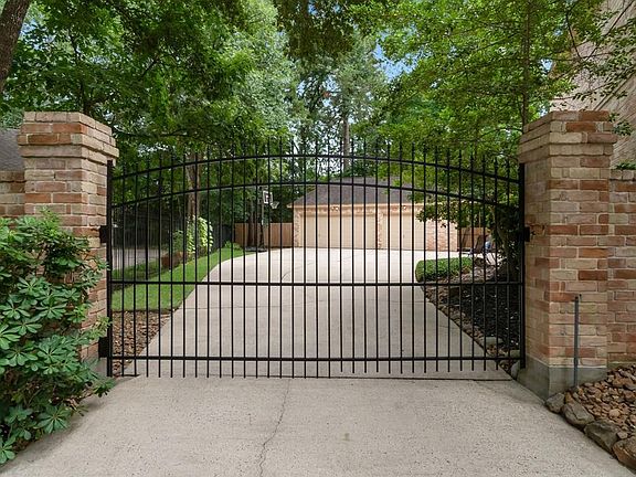 Driveway gate leading to large parking area and oversized 3 car garage!