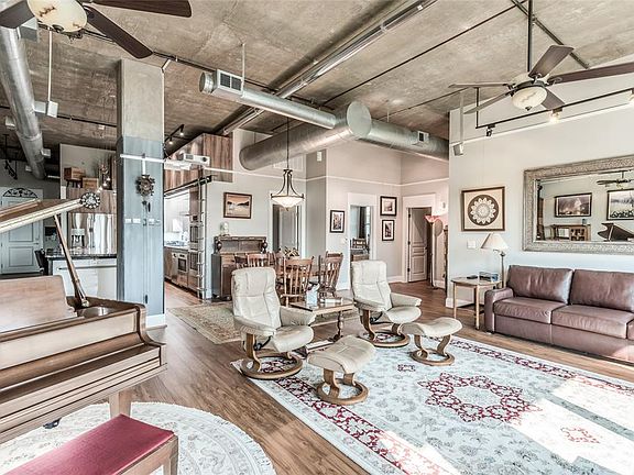 Large LR/DR is open to Kitchen seen in background. Water resistant, luxury vinyl plank floors run throughout the home, super easy to maintain! Door to right of Kitchen is walk-in Laundry Room, door to right of that is Primary Bedroom. Far Right door 