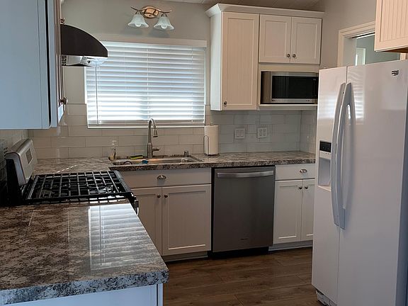 Kitchen has been completely remodeled. Walk-in pantry next to microwave.