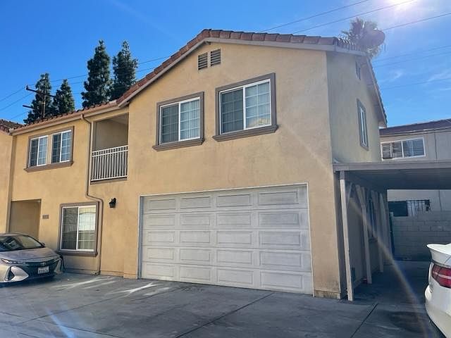 Front of Townhouse with carport parking to the right