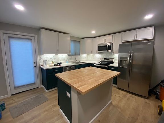 Kitchen with rear glass door to patio