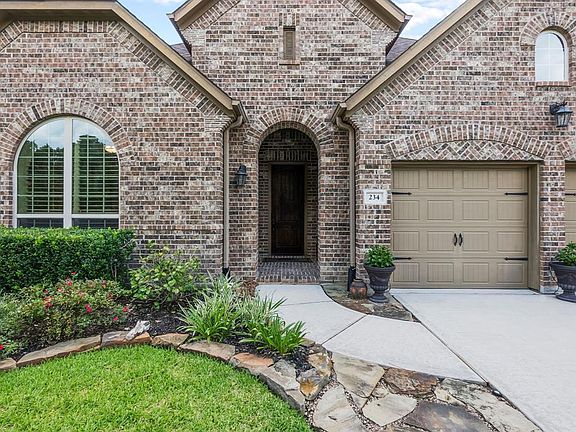Covered entry with a beautiful 12 foot mahogany door. 2 car garage.