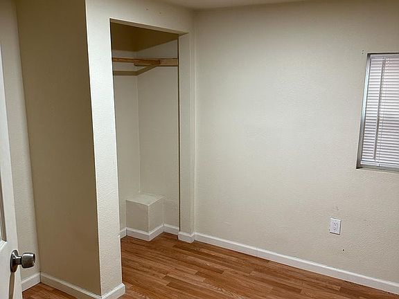 Bedroom one that features brand paint and flooring and has great lighting as well!