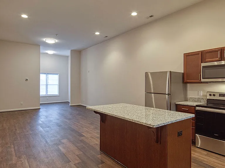 Brand-new, wood, nutmeg custom cabinets with granite