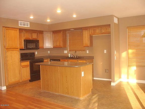 The kitchen and eating area overlook the pool and outdoor covered patio off the back of the house.