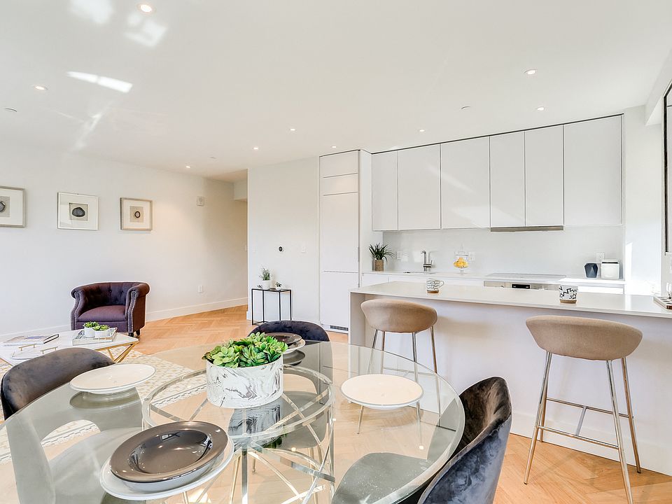 Open concept, newly renovated kitchen with Quartz countertops and an integrated fridge and dishwasher