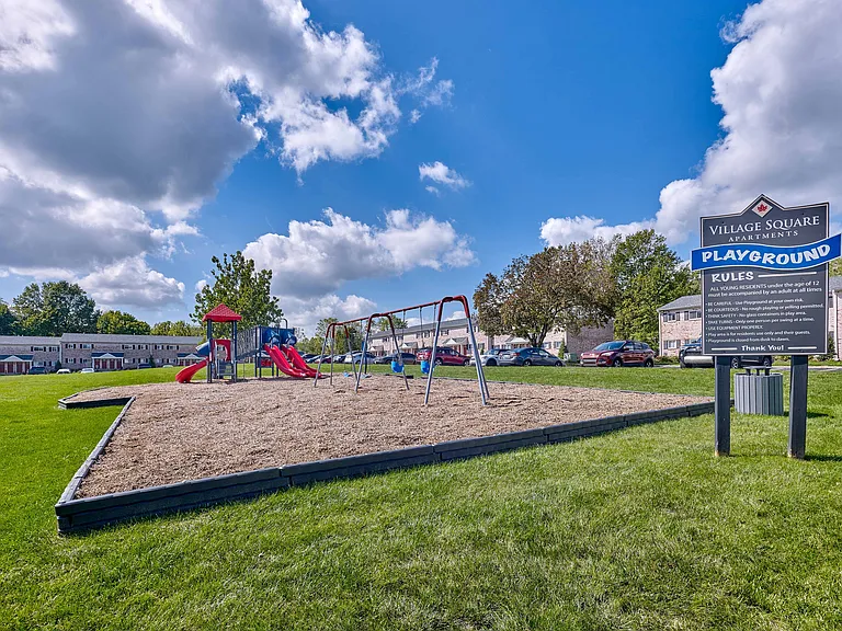 Village Square playground and lush landscaping.