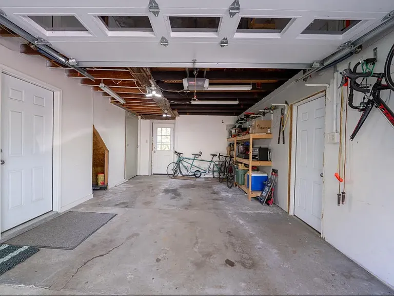 additional attic storage access in the door in the back on the left. door in the back leads outside to private yard and deck