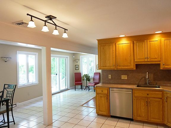 Open style kitchen with stainless steel appliances