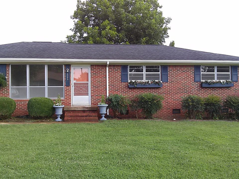 Great curb appeal with window flower boxes and mature landsc