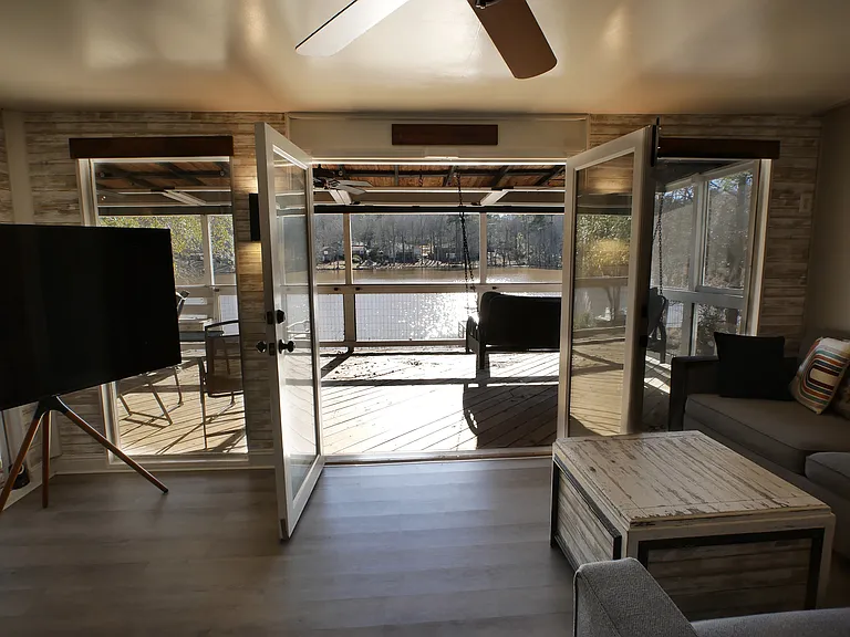 Sunroom with panoramic lake views, double french doors out to balcony, and dimmable lighting. Inquire about fully furnished option.