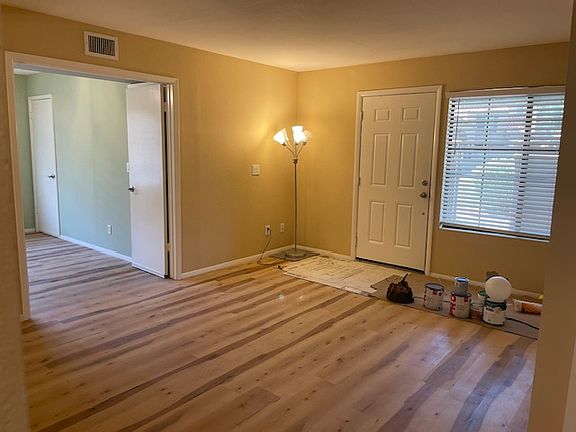 Living room with second bedroom on left side of photo.