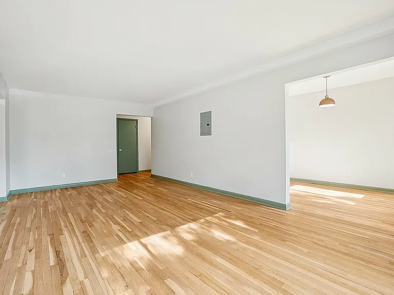 Bright, spacious living space with elegant hardwood flooring and modern design, perfect for creating your dream home.