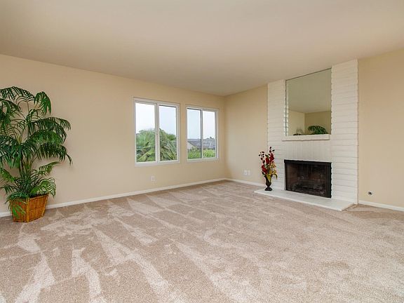 The formal Living Room has a brick fireplace.