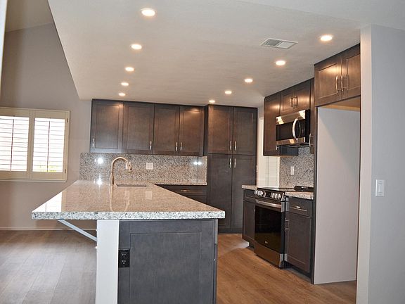 Long granite kitchen counter and seating area
Well lite kitchen