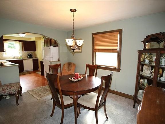 Newer Carpeting in 14x10 Dining Room w/ Newer Carpeting, Plaster Walls, Attractive Light Fixture & Beautiful Wood Trimwork