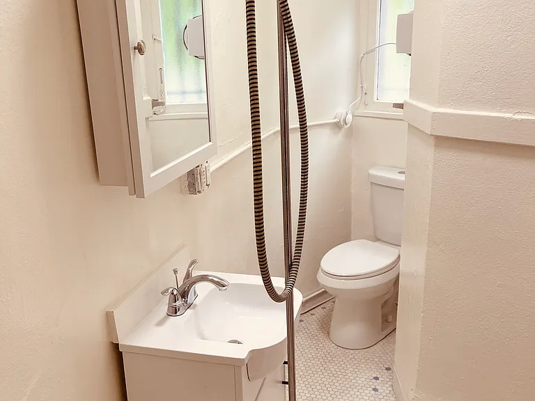 Bathroom with original tile floor, high ceilings