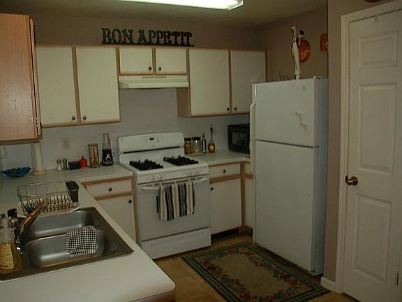 Kitchen has breakfast bar and opens to living room and dining area.  French doors allow plenty of light and great view of the back yard.