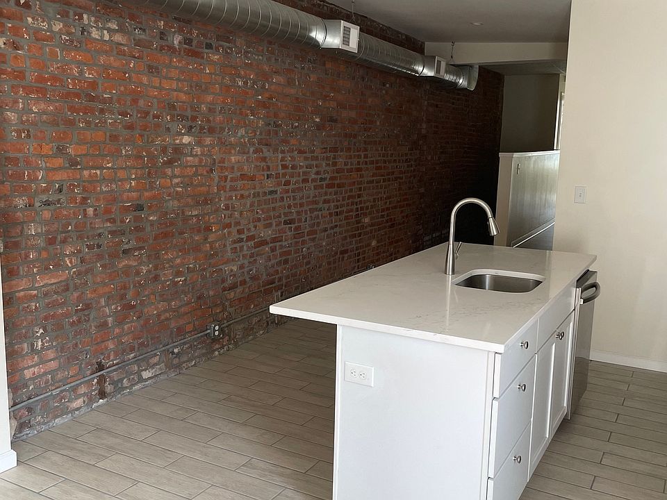 Kitchen with exposed brick and spiral ductwork