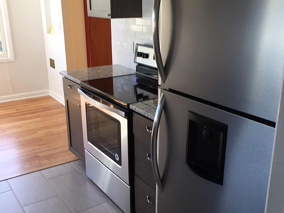 Stainless Steel appliances and tile floor.
