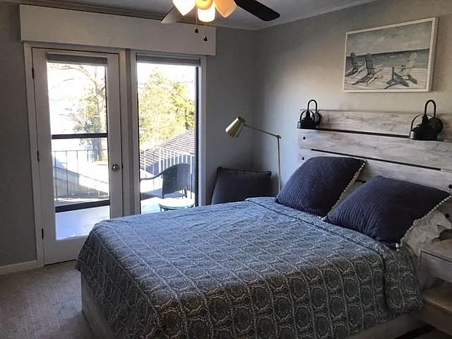 private bedroom with queen bed and private balcony access