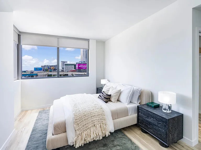 Serene bedroom retreat at Modera Riverside with soft finishes and sweeping Miami views.