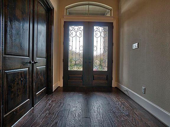 Wrought Iron Double Doors lead into the Foyer of the Custom Home.