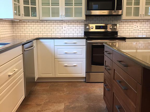 The kitchen has a newer convection oven, microwave with exhaust vent for the range, dishwasher, garbage disposal and refrigerator. Under-cabinet lighting and a charging station for your phones and tablets improve your efficiency.