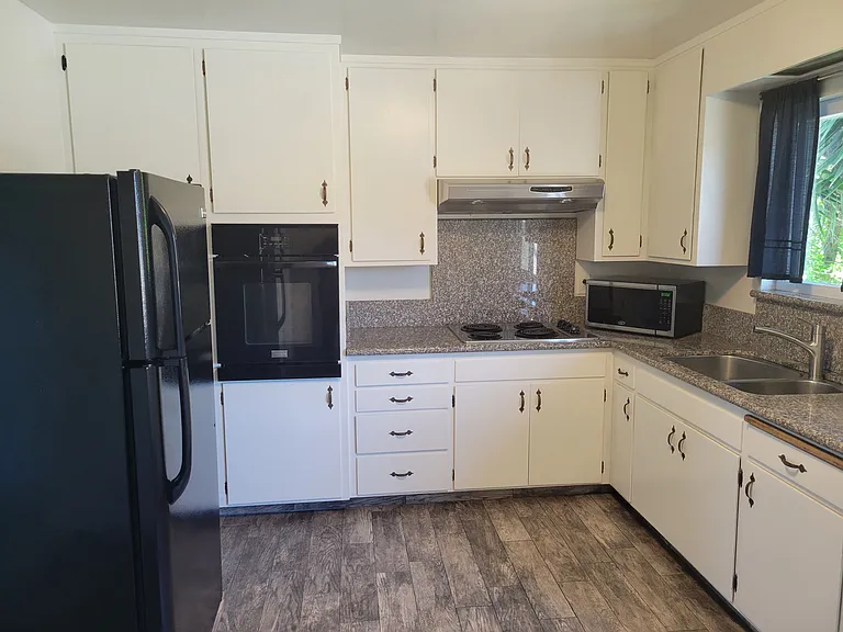 Spacious kitchen with granite counter tops.