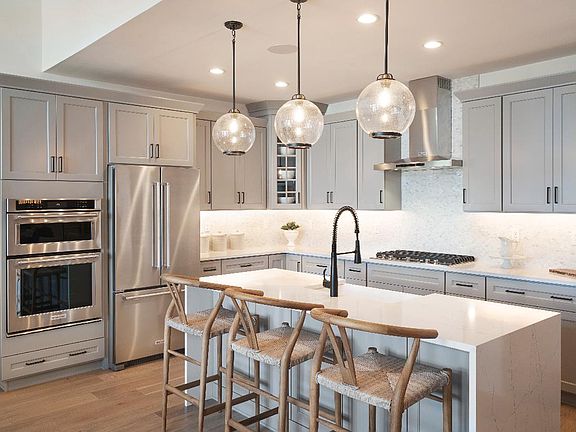 Upgraded cabinets and quartz countertops in the well-appointed kitchen
