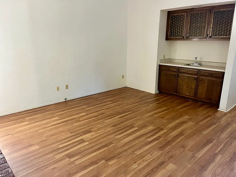 The family/entertaining room features a brick wood fireplace and a wet bar.