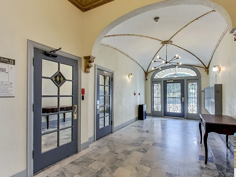 Hallway with a chandelier hanging from the ceiling