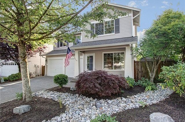 Picture perfect front porch, detailed landscaping and generous p