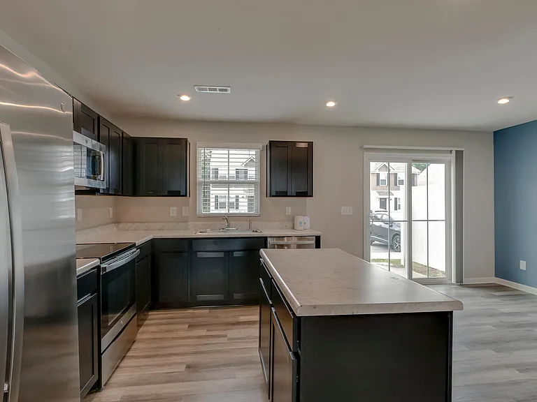 Kitchen and dining room located at the back of townhouse