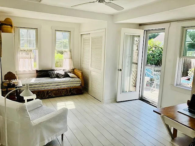 LR, BR has wide plank wood floors, ceiling fan, twin daybed, desk/dining table, large double closets, 4 windows, door opens onto private deck.