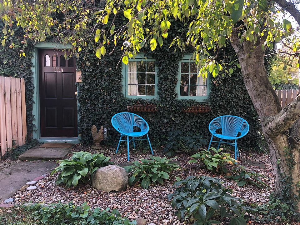 Ivy-covered cottage and shaded sitting area